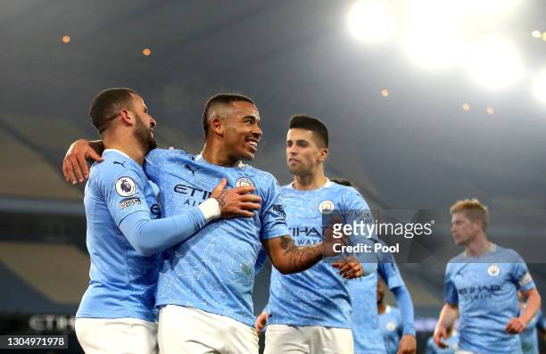 Gabriel Jesus of Manchester City celebrates with team mate Kyle Walker after scoring their side's second goal during the Premier League match between...
