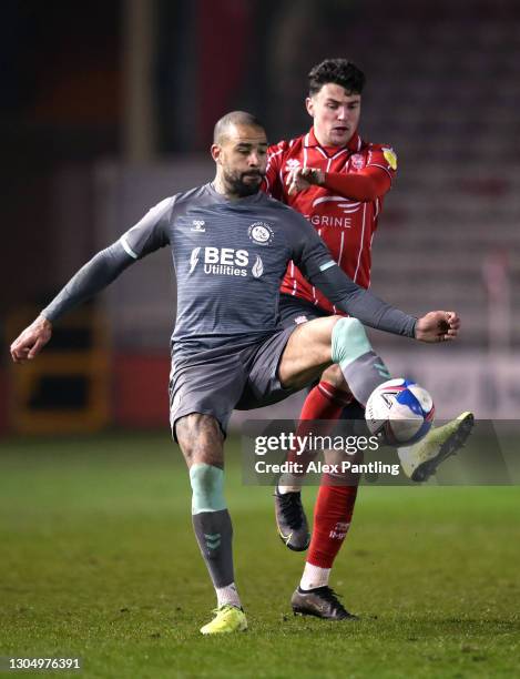 Kyle Vassell of Fleetwood Town and Regan Poole of Lincoln City clash during the Sky Bet League One match between Lincoln City and Fleetwood Town at...