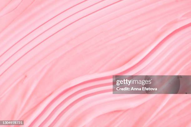 textured pink smears of cream for beauty procedures. trendy products of the year. health and wellness concept - pink background photos et images de collection