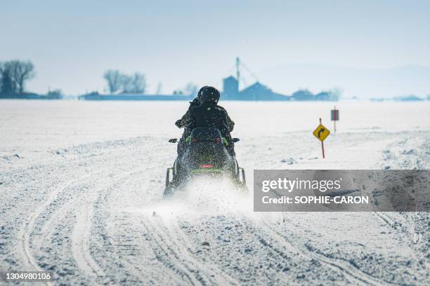 snowmobiles on snowy slopes - quebec icy trail stock pictures, royalty-free photos & images