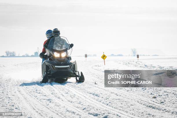 snowmobiles on snowy slopes - quebec icy trail stock pictures, royalty-free photos & images