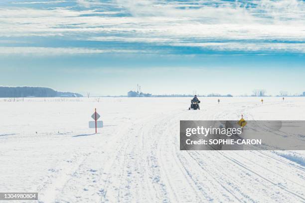 snowmobiles on snowy slopes - quebec icy trail stock pictures, royalty-free photos & images