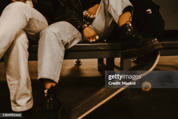 cropped image of friends with skateboard at subway - lower bildbanksfoton och bilder