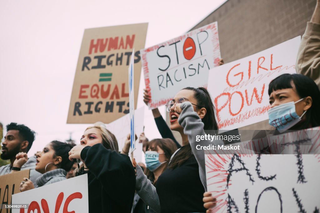 Male and female activists protesting for human rights in social movement