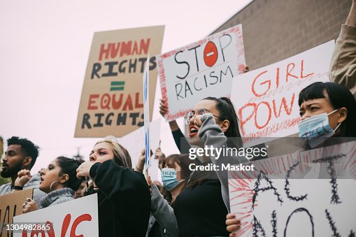 Male and female activists protesting for human rights in social movement Male and female activists protesting for human rights in social movement