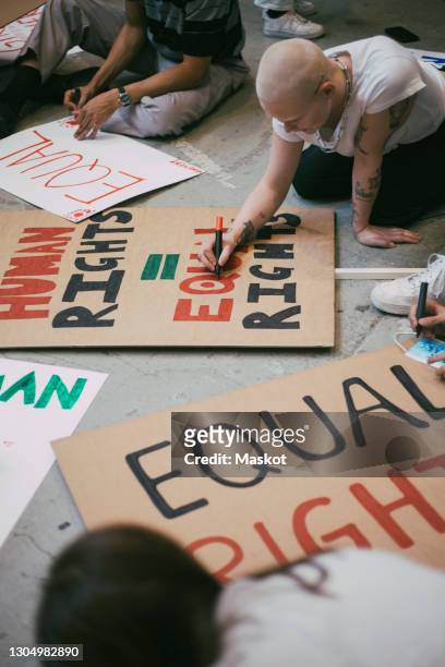 female activist preparing human rights signboard - justice concept stock pictures, royalty-free photos & images