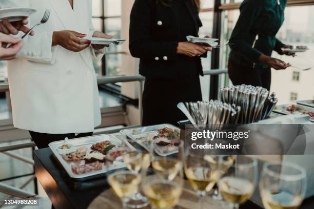 midsection of business people having meal during company party - smart casual lunch stock pictures, royalty-free photos & images