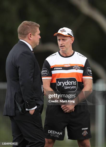 Tigers coach Michael Maguire speaks to Tigers officials during a Wests Tigers NRL training session at St Luke's Park North on March 03, 2021 in...