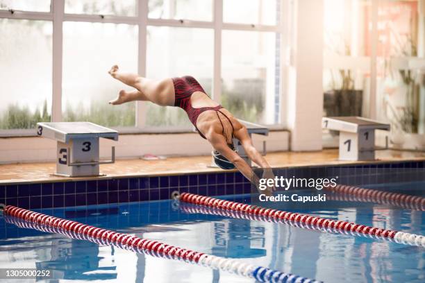 vrouwelijke zwemmer die in pool duikt - girl diving stockfoto's en -beelden