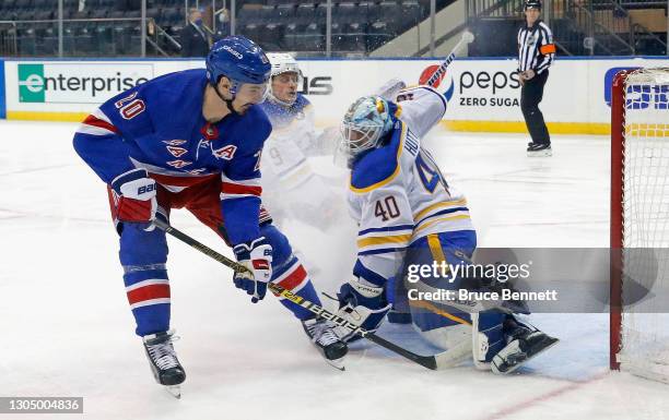 Carter Hutton of the Buffalo Sabres makes the third period save on Chris Kreider of the New York Rangers at Madison Square Garden on March 02, 2021...