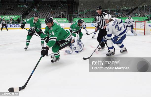 Jamie Benn of the Dallas Stars skates the puck against Ryan McDonagh of the Tampa Bay Lightning in the second period at American Airlines Center on...