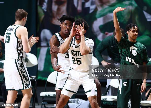 Malik Hall and Julius Marble II of the Michigan State Spartans celebrate from the bench in the second half of the game against the Indiana Hoosiers...