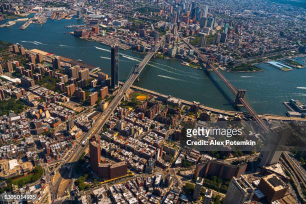 panoramic aerial view of two bridges, manhattan, dumbo, brooklyn, and downtown brooklyn from a helicopter. - lower east side manhattan stock pictures, royalty-free photos & images