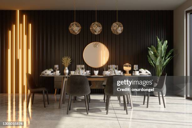 luxurious dining room interior with dining table, decorative objects, pendant lights and potted plant. - wood paneling stock pictures, royalty-free photos & images