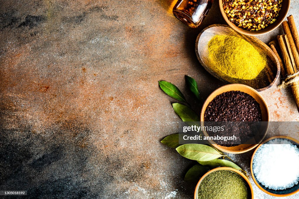 Overhead view of bowls of mixed herbs and spices on a table