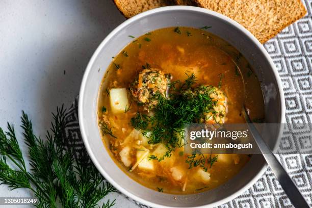 overhead view of a bowl of vegetable and meatball soup - dill stock pictures, royalty-free photos & images