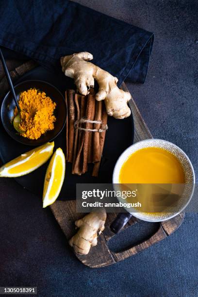 overhead view of a mug of turmeric moon milk with ingredients - honey lemon stock pictures, royalty-free photos & images