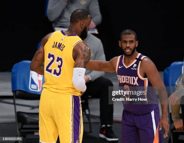 Chris Paul of the Phoenix Suns and LeBron James of the Los Angeles Lakers shake hands after a 114-104 Suns win at Staples Center on March 02, 2021 in...