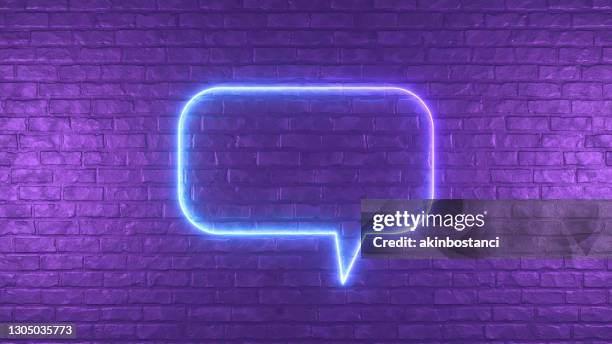 neon lighting glowing speech bubble on black brick wall - quotation text imagens e fotografias de stock