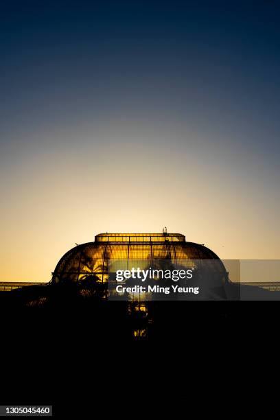 Sunsetting behind the Palm House at Kew Gardens on February 24, 2021 in London, England.