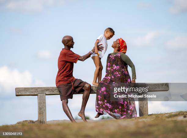 Mo Farah with his son Hussein and mother Aisha at Frensham Great Pond on July 12, 2019 in Farnham, England. This image is part of a series following...