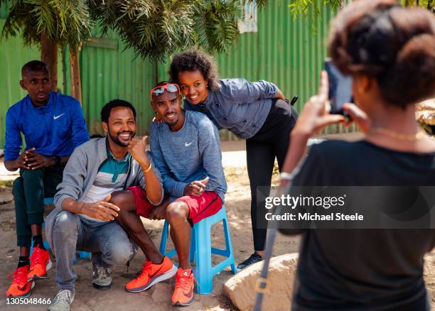 Mo Farah poses for a photo with fans as training partner Abdi Abdirahman looks on on February 11, 2018 in Addis Ababa, Ethiopia. This image is part...