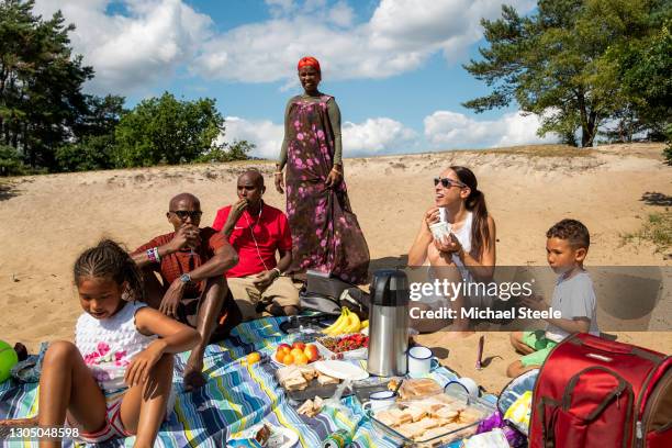 Mo Farah , wife Tania Farah, daughter Aisha, son Hussein, twin brother Hassan and mother Aisha enjoy a picnic at Frensham Great Pond on July 12, 2019...