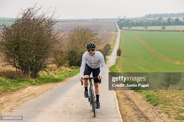 cyclist on road in countryside - endurance cyclist stock pictures, royalty-free photos & images