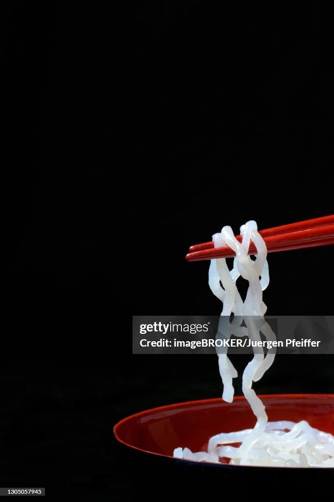 Shirataki noodles made from konjac flour on chopsticks, Germany