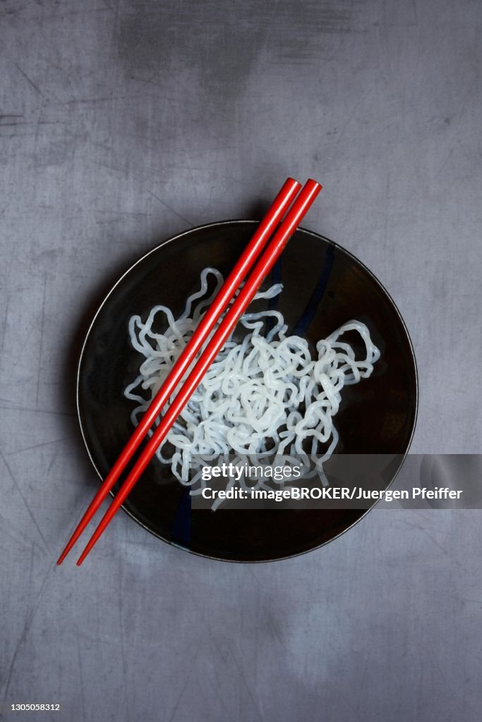 Shirataki noodles made from konjac flour in a bowl with chopsticks, Germany