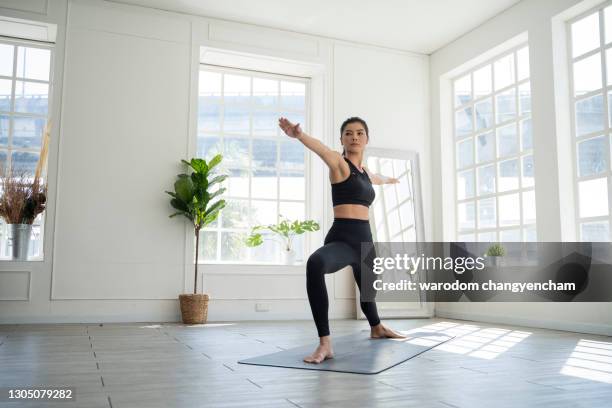 woman doing yoga exercise at home. - quarantäne stock-fotos und bilder