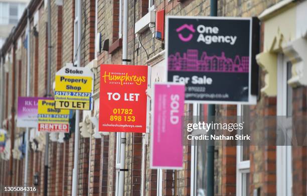 Placards from various estates agents advertising properties To Let , For Sale and Sold on March 03, 2021 in Stoke-on-Trent, England. UK Chancellor,...