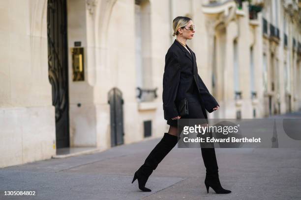 Emy Venturini wears sunglasses from Victoria Bekham, earrings from Toledano, a golden necklace, a black double breasted oversized blazer jacket from...