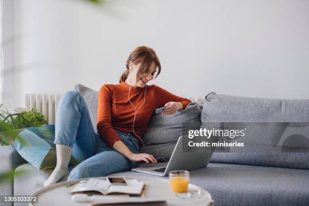 women in business: beautiful smiling businesswoman using a laptop for online shopping while working from home - relaxed online imagens e fotografias de stock