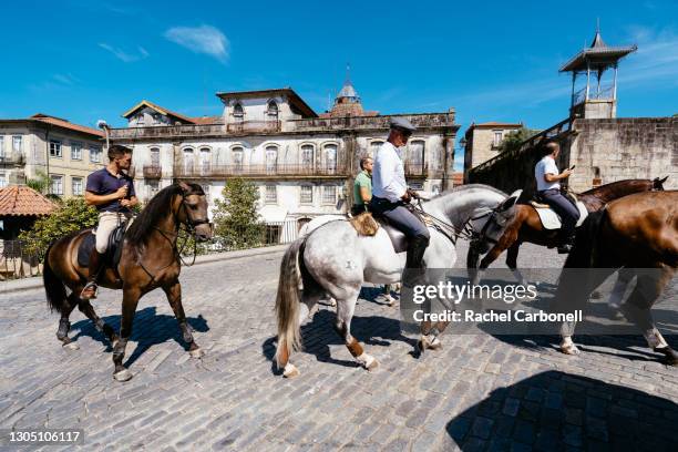 horse riders on their horses on the streets of the old town. - ponte de lima stock pictures, royalty-free photos & images