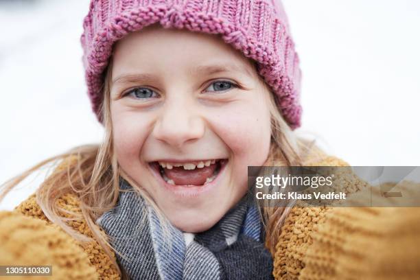 happy cute girl in warm clothing - gray eyes stock-fotos und bilder