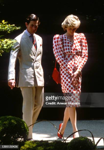 Prince Charles, Prince of Wales and Diana, Princess of Wales, wearing a white dress with large red polka dots or 'rising suns' from Tatters with a...