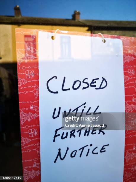 closed until further notice sign in bold colours - closed until further notice stock pictures, royalty-free photos & images