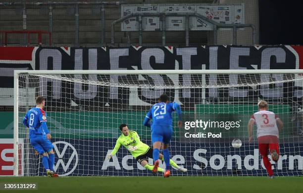 Alexander Muhling of Holstein Kiel scores their sides first goal past Daniel Davari of Rot-Weiss Essen from the penalty spot during the DFB Cup...