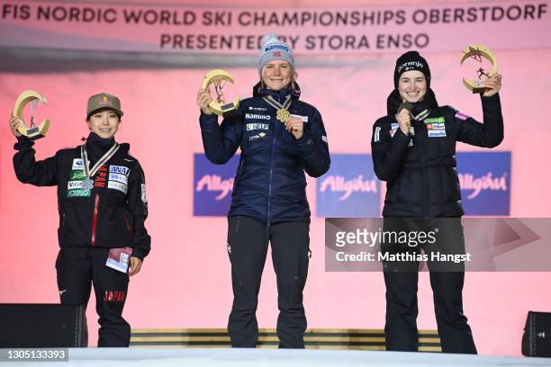 Silver medalist Sara Takanashi of Japan, Gold medalist Maren Lundby of Norway and Bronze medalist Nika Kriztnar of Slovenia celebrate during the...