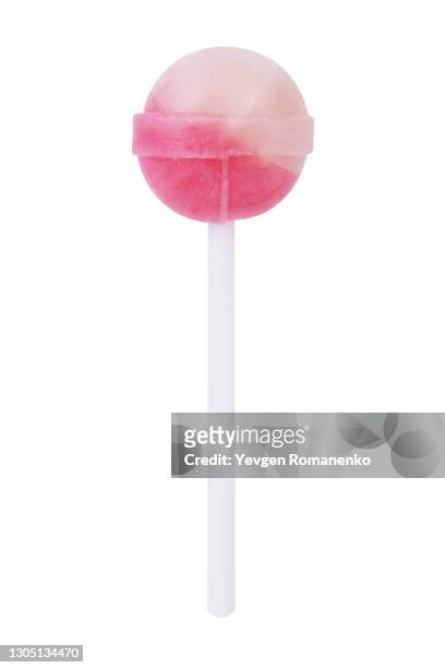 pink lollipop on a stick isolated on white background - lolly stockfoto's en -beelden