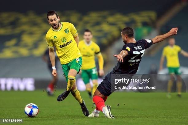 Mario Vrancic of Norwich City is challenged by Winston Reid of Brentford during the Sky Bet Championship match between Norwich City and Brentford at...