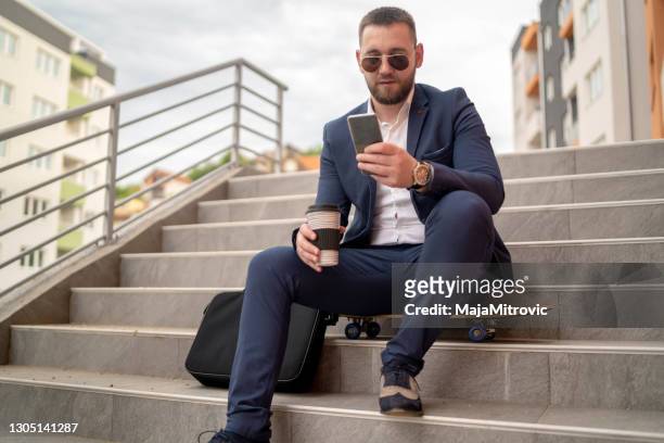 hipster texting on the stairs - man check suit stock pictures, royalty-free photos & images