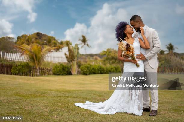 bride and groom kissing - african ethnicity wedding stock pictures, royalty-free photos & images