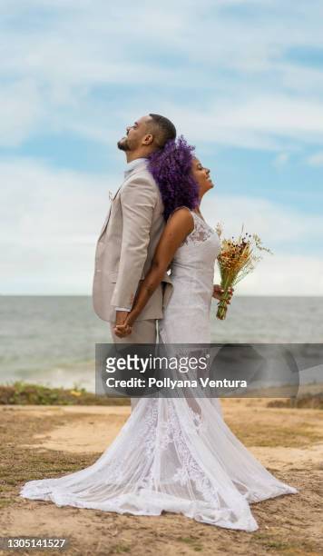 happy newlyweds on the beach - black couple wedding stock pictures, royalty-free photos & images