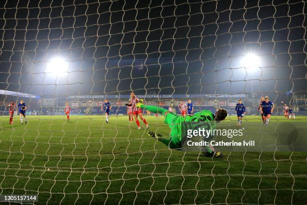 Ann-Katrin Berger of Chelsea saves a penalty from Deyna Castellanos of Atletico de Madrid during the Women's UEFA Champions League Round of 16 match...