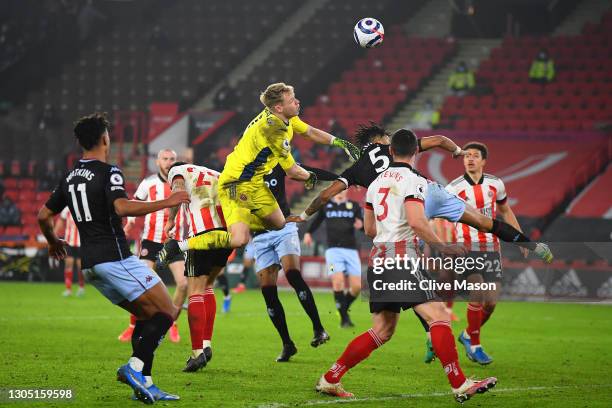 Aaron Ramsdale of Sheffield United clears the ball under pressure from Tyrone Mings of Aston Villa during the Premier League match between Sheffield...