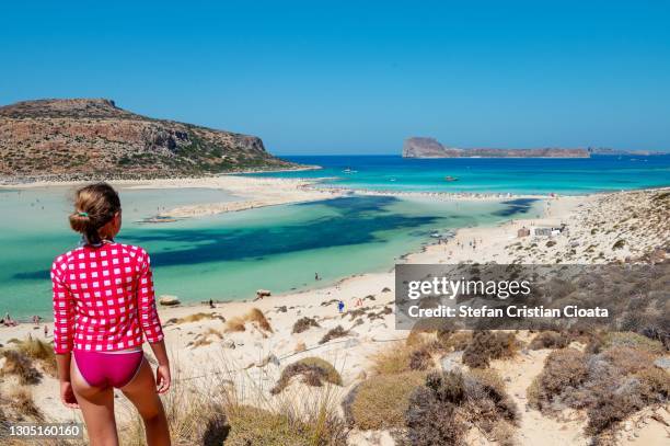 girl admiring balos beach, crete - balonnen stock-fotos und bilder