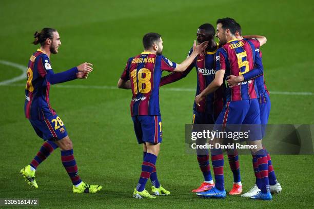 Ousmane Dembele of FC Barcelona celebrates with teammates Jordi Alba and Sergio Busquets after scoring their team's first goal during the Copa del...