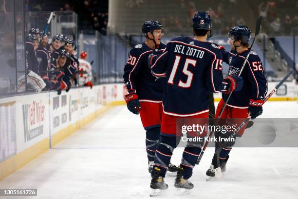 Riley Nash of the Columbus Blue Jackets is congratulated by Emil Bemstrom and Michael Del Zotto after scoring a goal during the game against the...